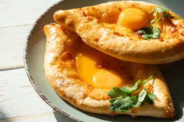 two Adjarian khachapuri in traditional classic Georgian style.