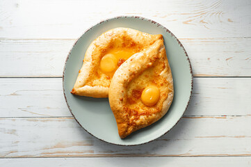two Adjarian khachapuri in traditional classic Georgian style.