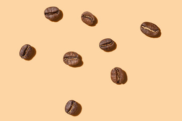 Coffee beans on a beige background hard light