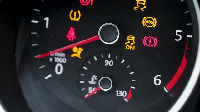 Tachometer Gauge of Starting and Stopping Car. Starting car engine. Dashboard in the car. Many different car dashboard lights with warning lamps illuminated