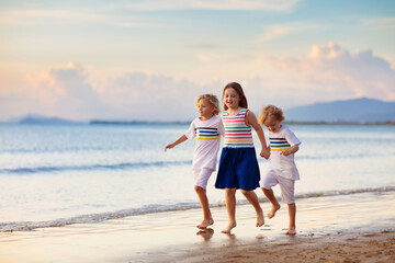 Kids play on tropical beach. Sand and water toy.
