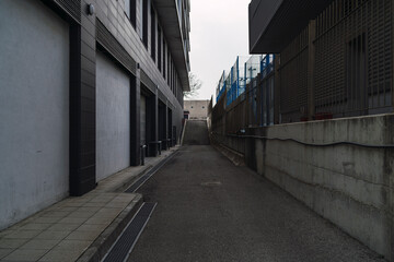 Vertical shot of a walkway through buildings

