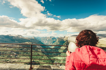 Fototapeta na wymiar Tourist looking through binoculars in mountains, Norway