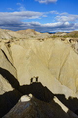 Shadow of two people on rock mountain