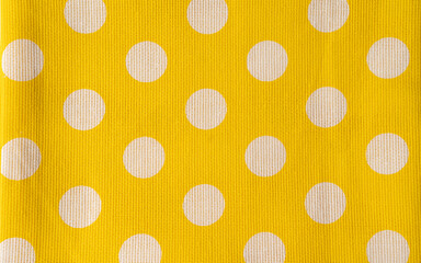 The real polka dots yellow background. Close up shot of napkin.