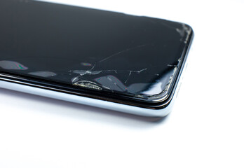 Broken protective glass on the smartphone screen.
