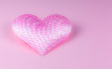 Pink heart on pink background. Saint Valentine's day concept. Love and romantic photo. Postcard for holiday. Beautiful warm wallpaper with love. Soft focus. Copy space.