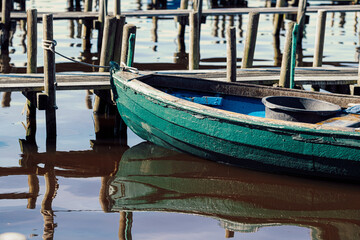 Fototapeta na wymiar green wooden fishing boat on pier