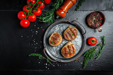 Medallions steaks from the beef tenderloin covered bacon on grill dark background. top view