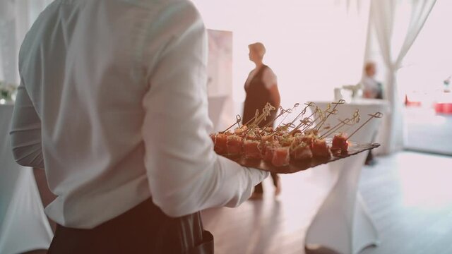 Male Waiter Serving Catering On Banquet And Holding Meat Snack On Plate