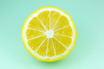 Close up photo of lemon texture on the blue background. Fruit cut in half, inside, macro view. Minimalism, original beautiful photo.