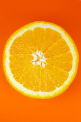 Orange fruit on orange background.  Minimalism, original beautiful photo.