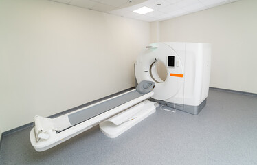 Tomography scanner in hospital ward. Selective focus on MRI table with no patient. Modern MRI equipment in clinic. Closeup.