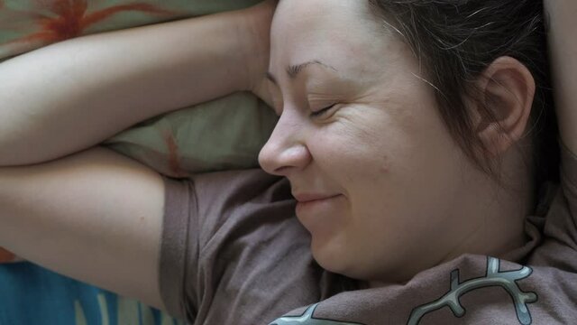 the awakening of a young woman. a smile on his face. morning in bed