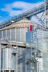 Metal cisterns at granary. Special tanks for long term wheet and barley storage. Selective focus from drone. Closeup.