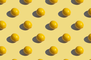 Yellow lemon on a yellow background. Lemon pattern on yellow background background. Hard shadows