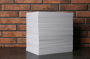 Stack of paper sheets on black table