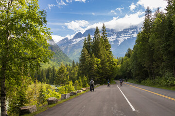 Biker on the Going-to-the-Sun Road with mountain background, Glacier National Park, Montana