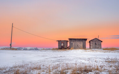 Fototapeta premium Minimalist landscape. Wooden fish smokehouses in authentic village of Teriberka.