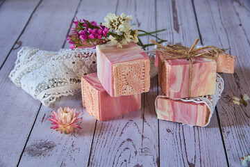 Pink textured handmade soap on a gray background.