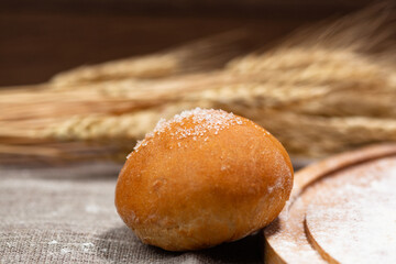 homemade bun against the background of wheat ears