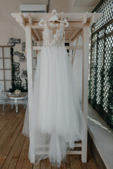 wedding morning. white wedding dress on a hanger. High quality photo