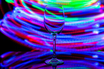 wine glass against the background of colored bright stripes