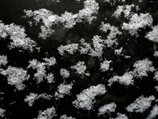 large white snowflakes on a dark background