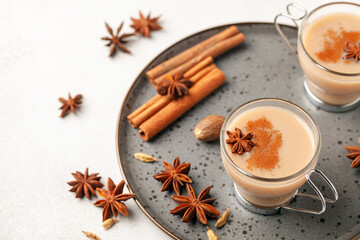 Masala tea in a glass cup with cardamom, star anise and cinnamon. Antiviral drink for immunity.