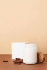 Beautiful white candle with cinnamon sticks on brown solid background