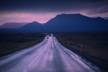 Drive car on road. Iceland travel. Beautiful nature icelandic landscape in pink sunset