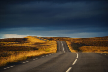 Iceland travel. Drive car on the road. View from the inside. Beautiful nature icelandic landscape at sunset