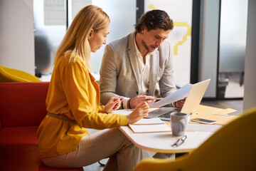 Fototapeta premium Concentrated young female person looking her notes