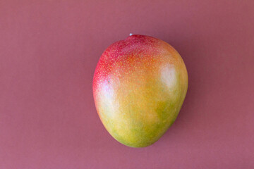 Fresh delicious mango isolated on brown background
