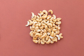 group of nuts on brown background, healthy food concept, empty space for text
