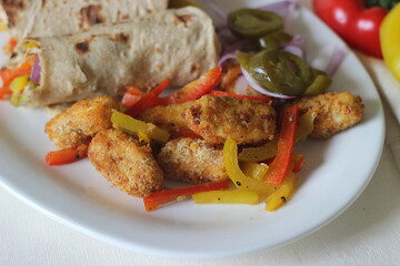 Paneer bell pepper rolls. Breaded and air fried cottage cheese, sauteed bell peppers, fresh chopped onions and jalapenos rolled in whole wheat Indian flat bread.