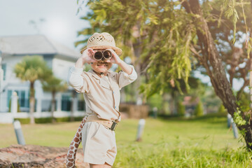 asian kid boy looking up to sky in jungle.Adventure.Staycation outdoor.toddler boy with spyglass.Travel adventure, Explore world,Imagination dream, Travel, Safari.DIY activity. education explore.