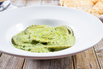 A view of a plate of pesto ravioli.