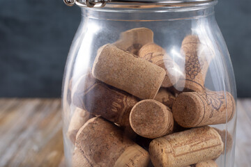 A view of many wine corks inside a glass jar.