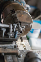 metalworking industry: working on a lathe with flying sparks. Lathe