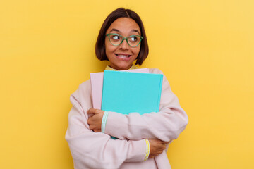 Fototapeta premium Young mixed race student woman isolated on yellow background