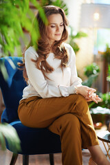pensive stylish female with long wavy hair in sunny day