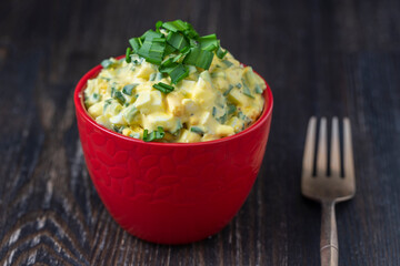 Healthy salad of green wild leek, poached egg and sour cream. Wild garlic salad with boiled eggs