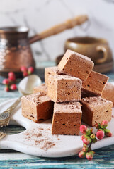 Homemade chocolate marshmallows cubes sweets and coffee cup