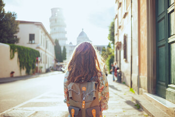 Seen from behind woman in floral dress having walking tour