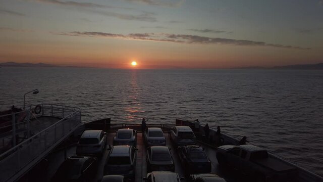 Cars aboard BC Ferry enjoying sunset towards Vancouver Island during a summer evening