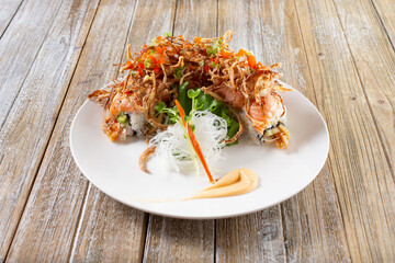 A view of a salmon roll with a crispy onion nest.