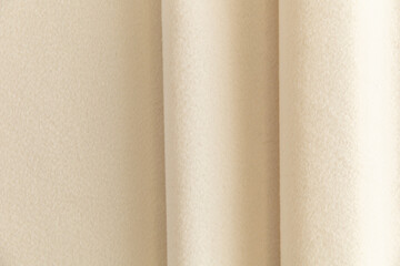 surface of light cream fleece, draped with folds, background
