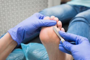 Professional pedicure using dieffenbach scalpel. Medical pedicure procedure using special...