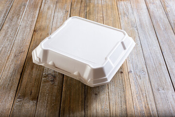A view of a food styrofoam container on a table.